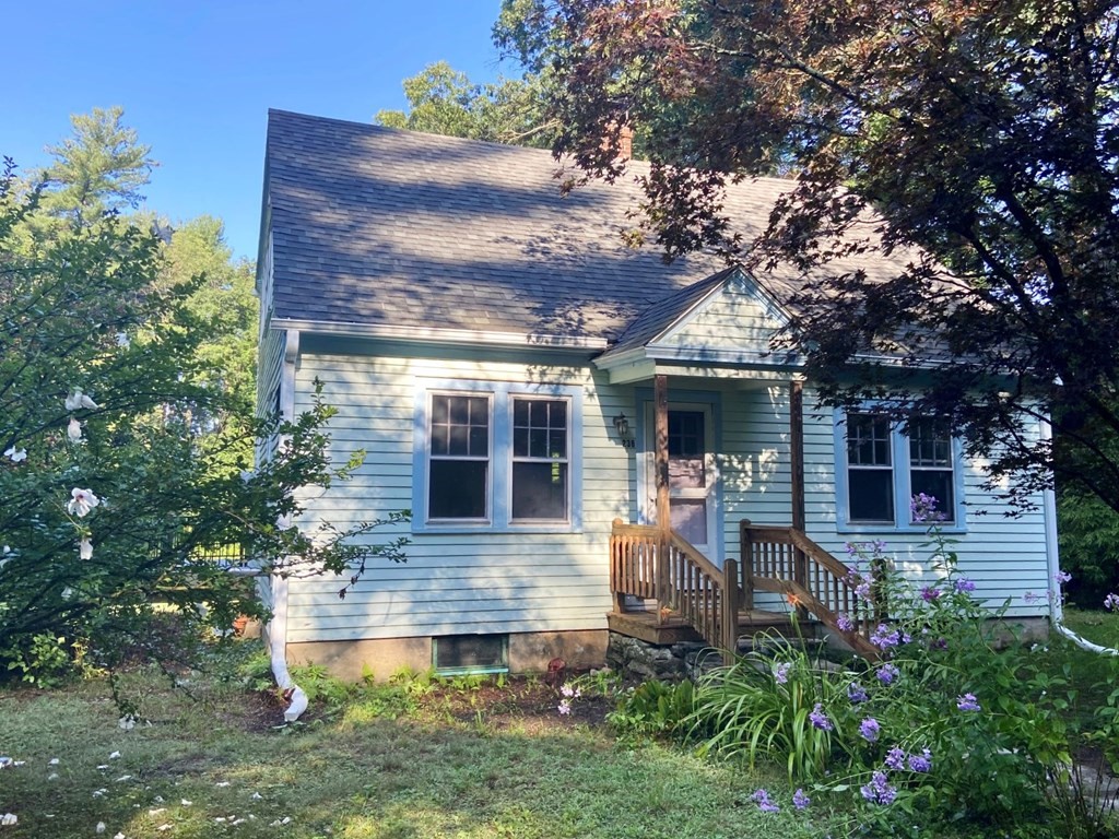 a front view of house with yard and outdoor seating