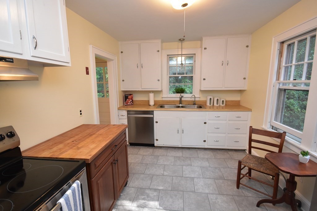 236 Harkness Road Amherst, MA 01002 - Photo 12 of 41 a kitchen with a stove a sink a window and cabinets