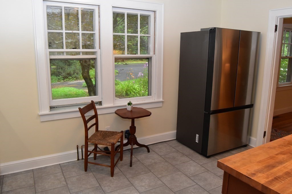 236 Harkness Road Amherst, MA 01002 - Photo 14 of 41 a view of a kitchen with a window and a refrigerator