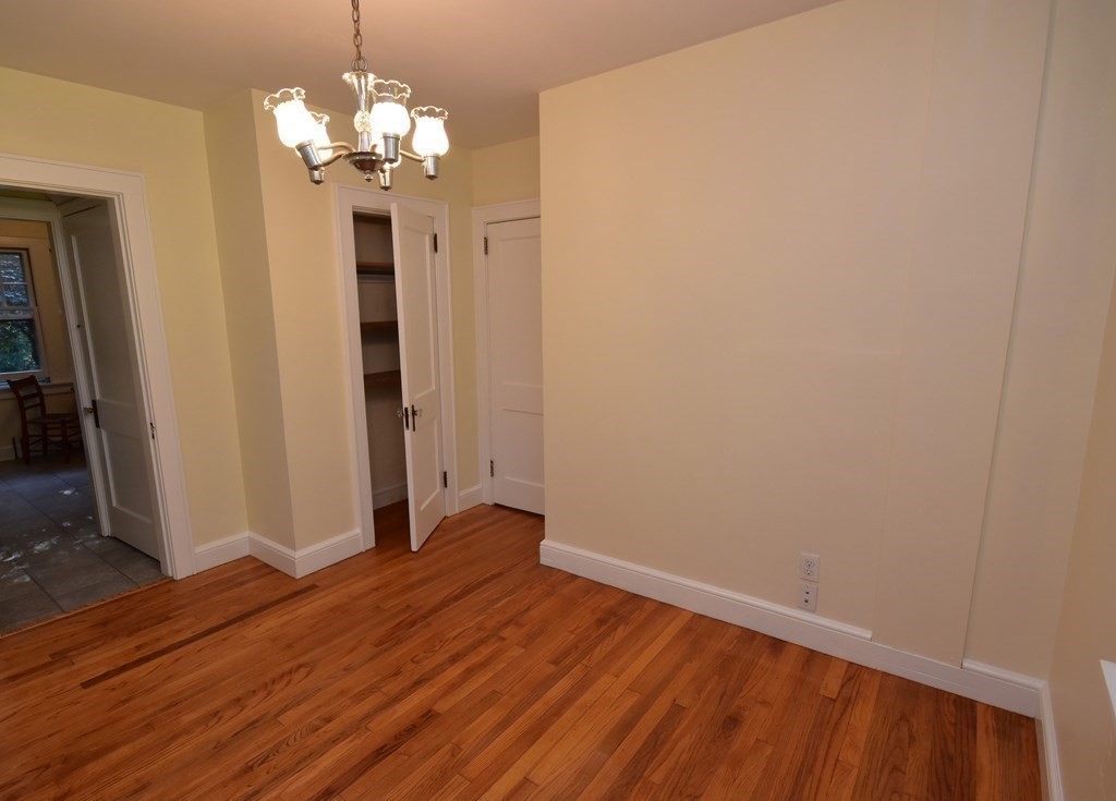 236 Harkness Road Amherst, MA 01002 - Photo 19 of 41 a view of a chandelier in big room with wooden floor