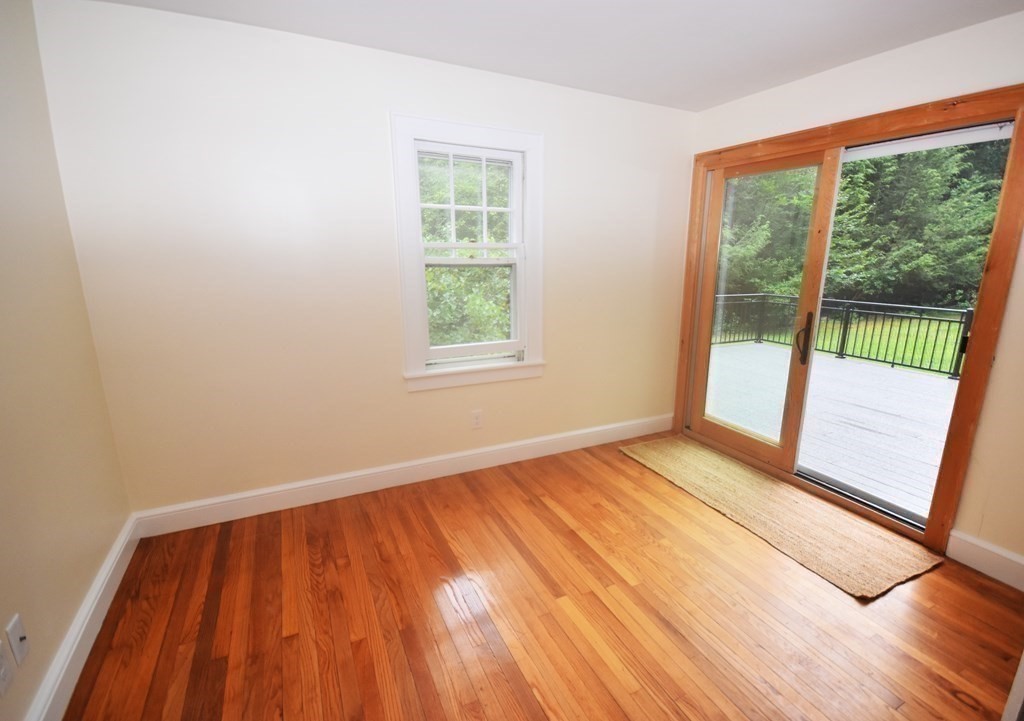 236 Harkness Road Amherst, MA 01002 - Photo 20 of 41 a view of an empty room with wooden floor and a window