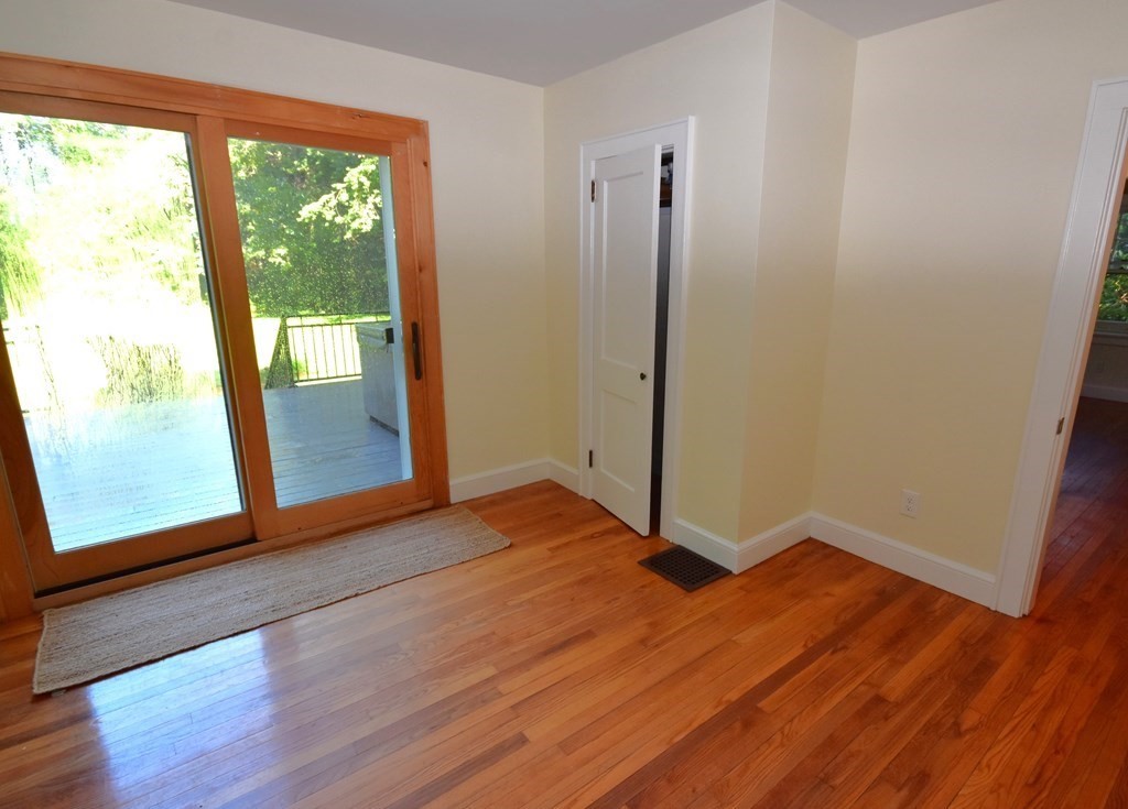 236 Harkness Road Amherst, MA 01002 - Photo 21 of 41 a view of an empty room with glass door and wooden floor
