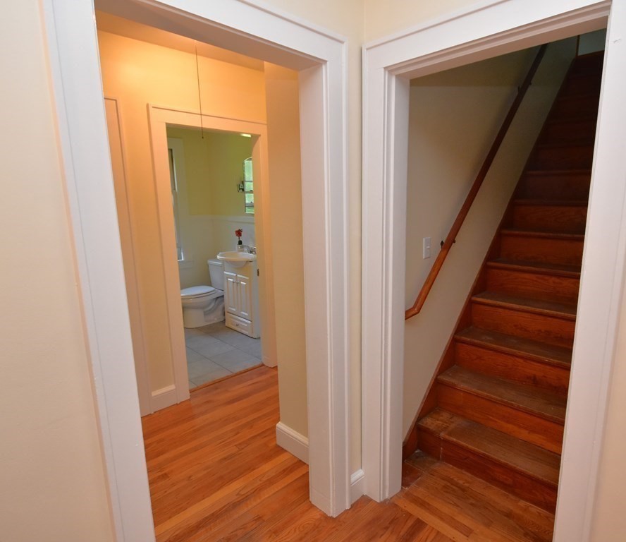 236 Harkness Road Amherst, MA 01002 - Photo 25 of 41 a view of a hallway with wooden floor and a bathroom