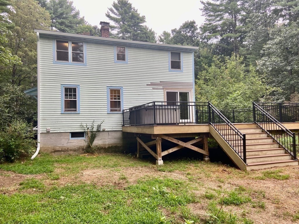 236 Harkness Road Amherst, MA 01002 - Photo 33 of 41 a backyard of a house with wooden deck and outdoor seating