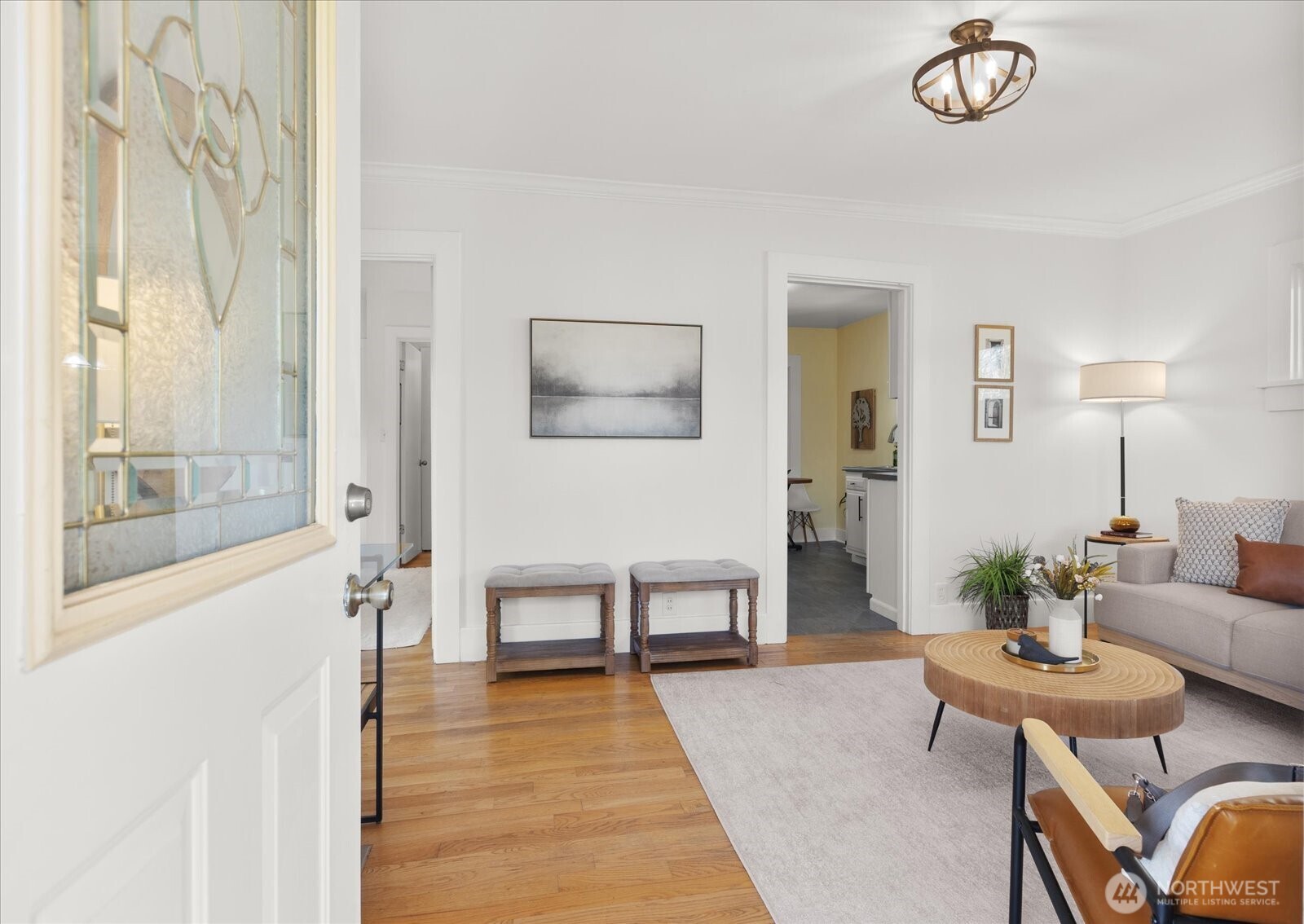7729 18th Avenue Southwest Seattle, WA 98106 - Photo 11 of 36 a living room with furniture a table and a painting on the wall