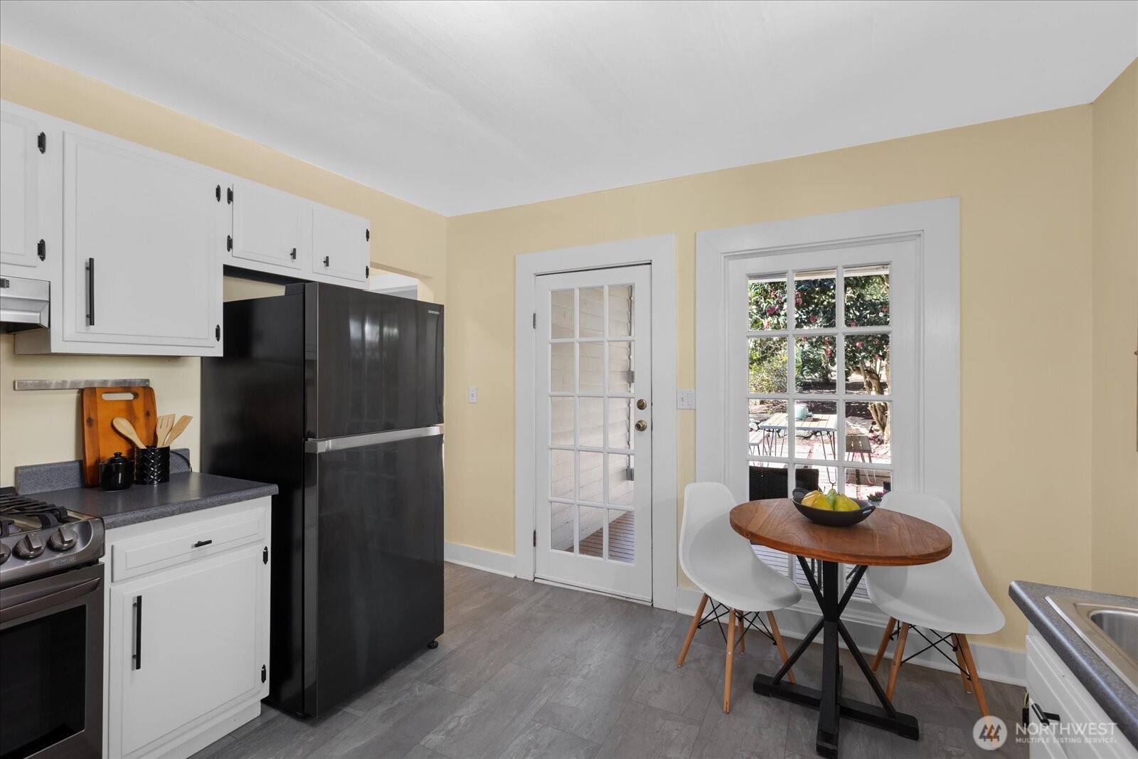 7729 18th Avenue Southwest Seattle, WA 98106 - Photo 20 of 36 a kitchen with stainless steel appliances a refrigerator and a stove top oven