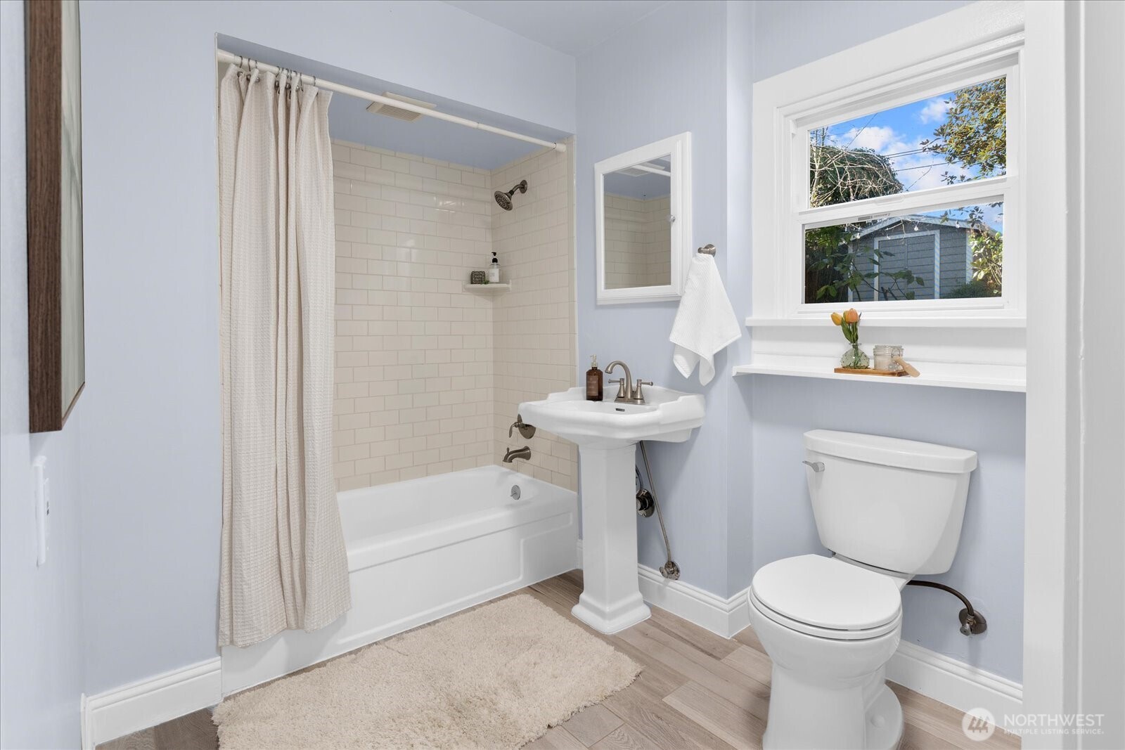 7729 18th Avenue Southwest Seattle, WA 98106 - Photo 21 of 36 a bathroom with a toilet sink and mirror