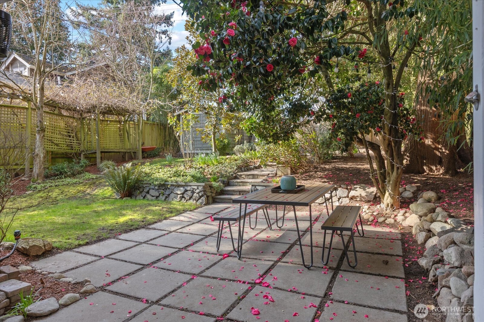 7729 18th Avenue Southwest Seattle, WA 98106 - Photo 29 of 36 a view of backyard with table and chairs and potted plants