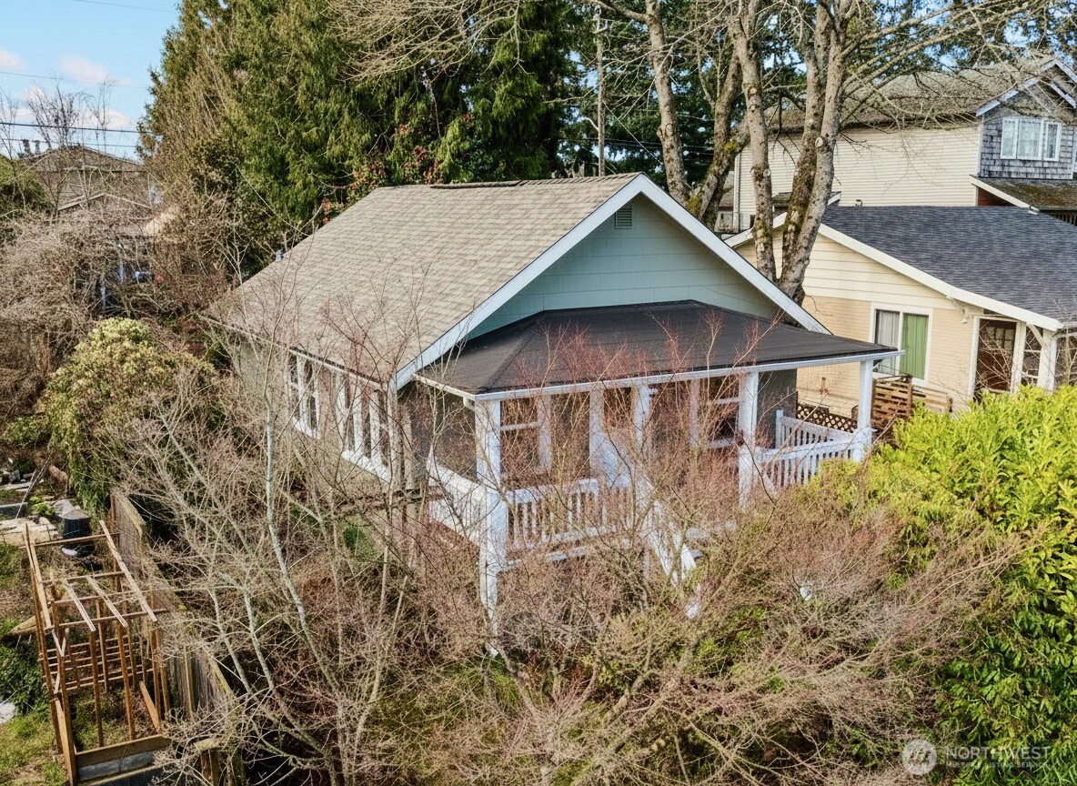 7729 18th Avenue Southwest Seattle, WA 98106 - Photo 4 of 36 aerial view of a house with yard and trees in the background