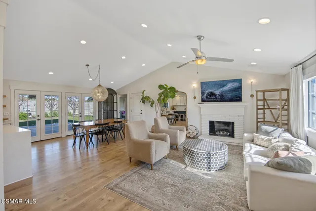 a living room with furniture a fireplace and a table