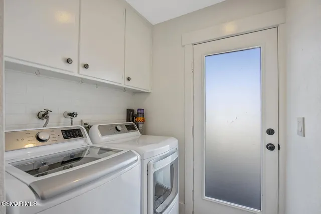 a bathroom with a toilet sink vanity and shower