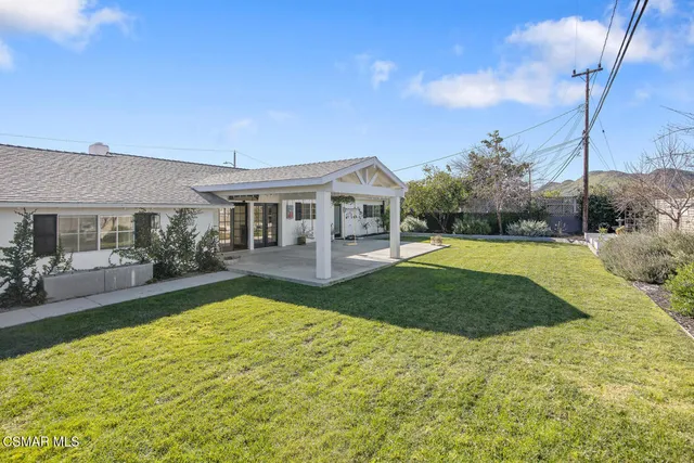 a view of a backyard with porch and garden