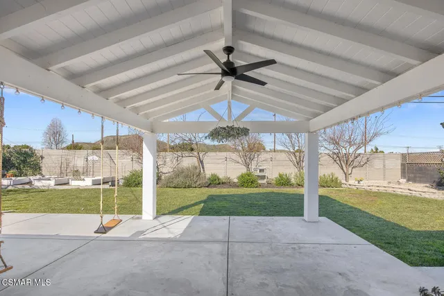 a view of a backyard with wooden fence
