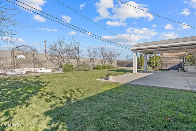 a view of house with garden and swimming pool
