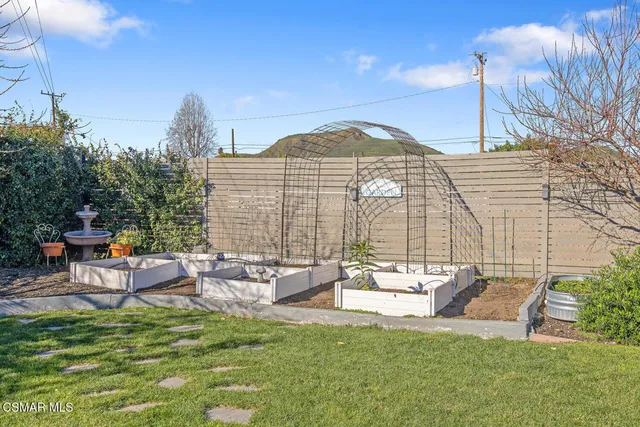 a view of a house with a yard and sitting area