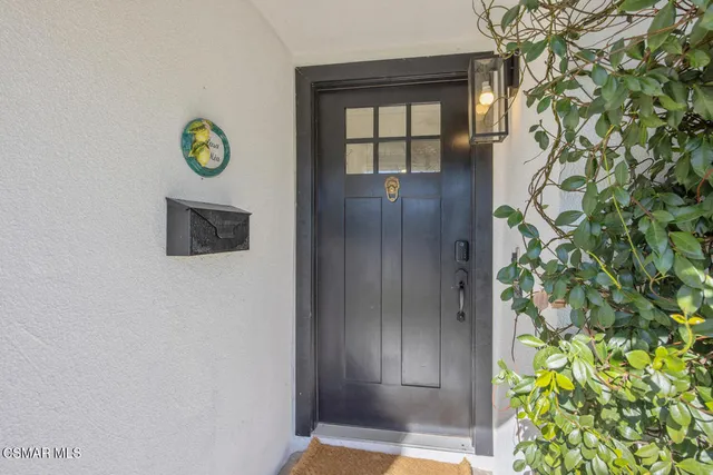a living room with furniture a fireplace and a potted plant