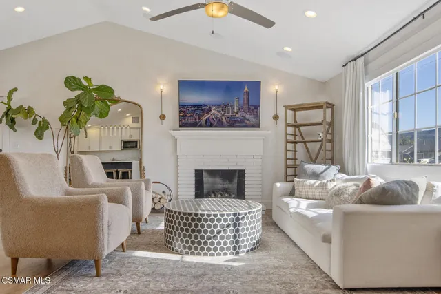 a living room with fireplace furniture and a wooden floor
