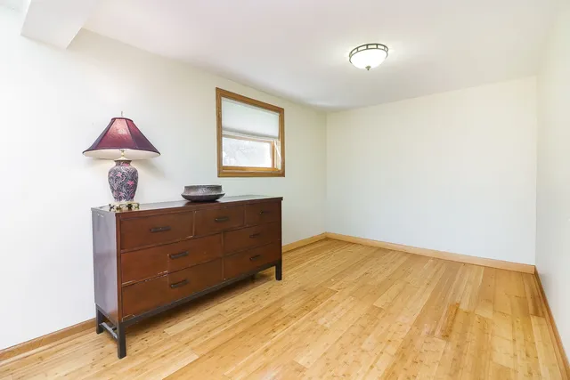 a room with a dresser and a window