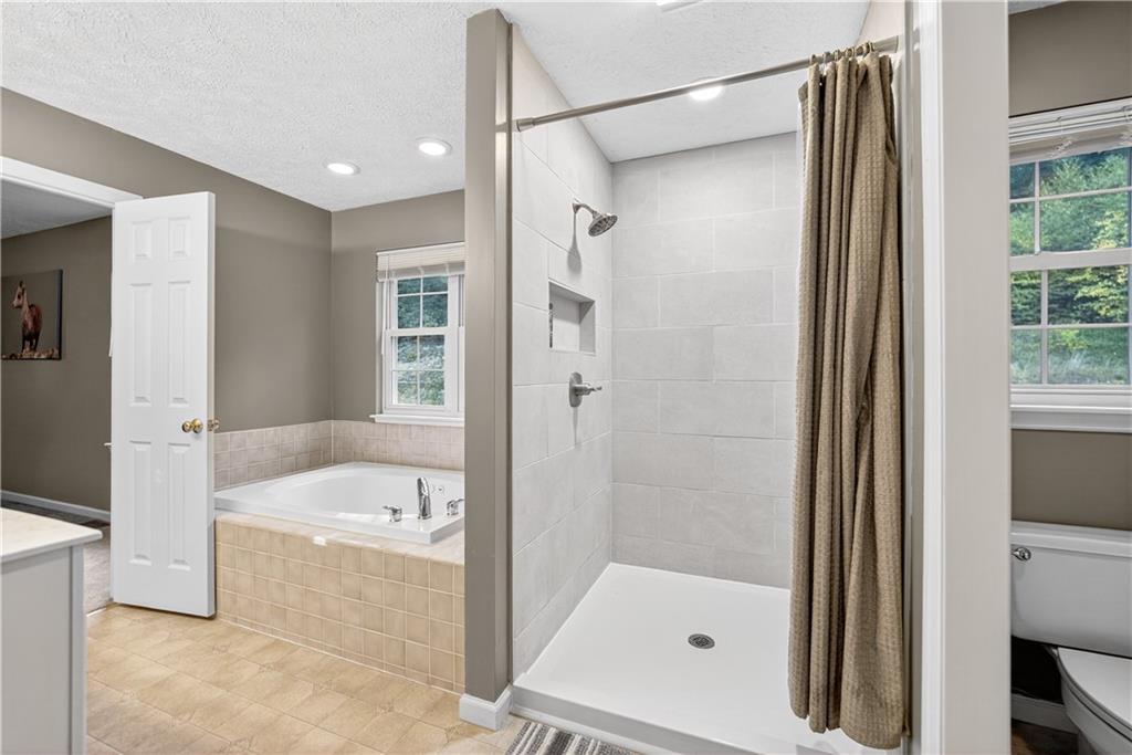 139 Ladybug Lane Ligonier, PA 15658 - Photo 21 of 33 a bathroom with a bathtub and a shower