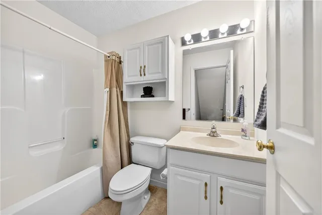 a bathroom with a sink a toilet a mirror and shower