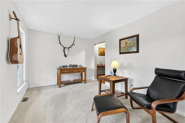 a room with furniture pool table and window