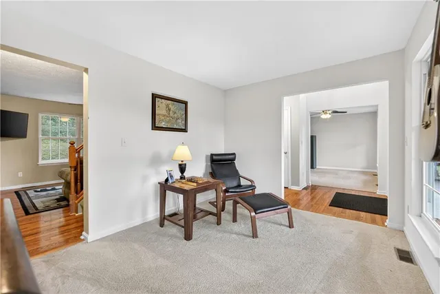 a livingroom with workspace and a couch