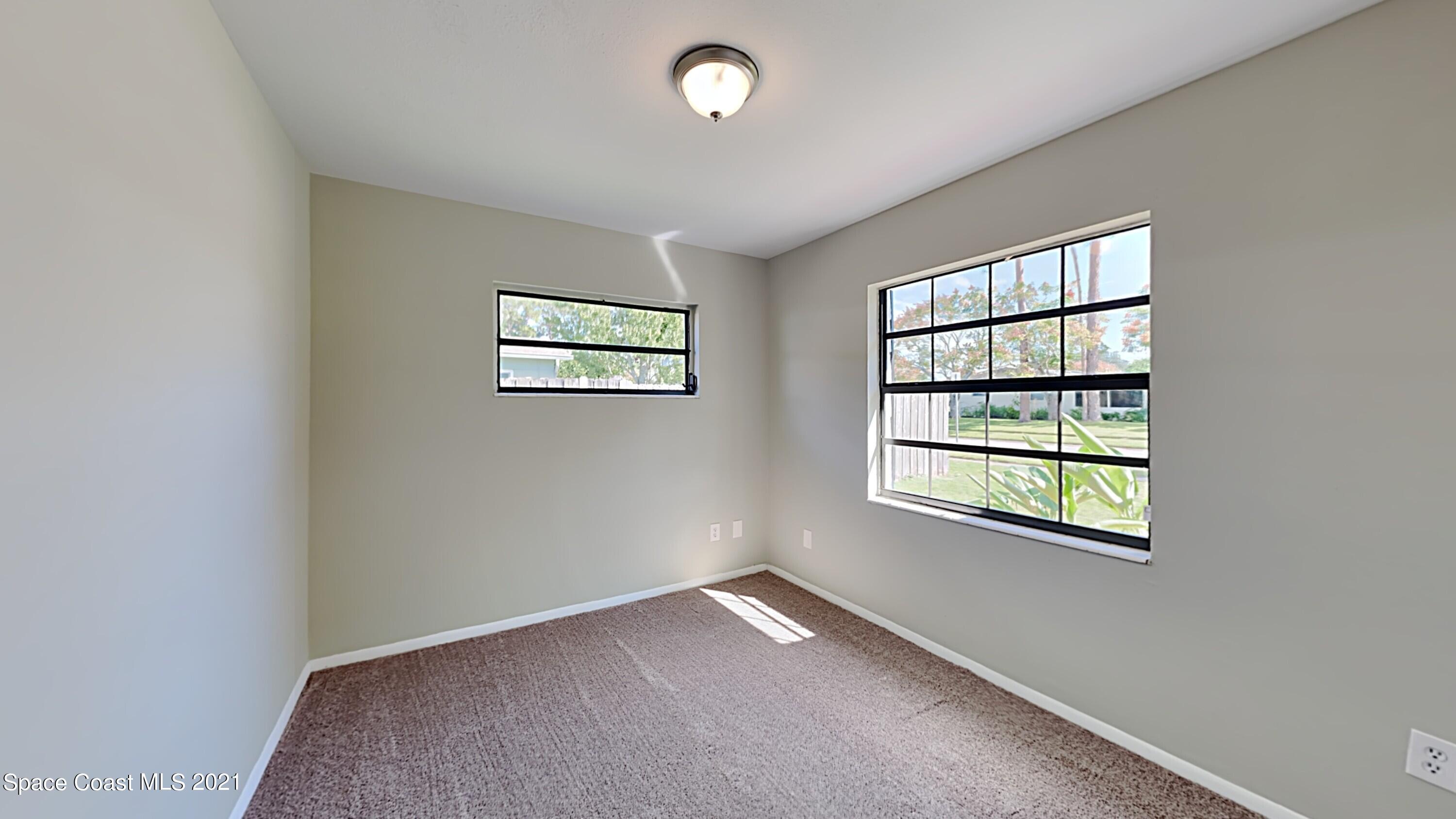 955 Lexington Road Rockledge, FL 32955 - Photo 11 of 18 an empty room with windows