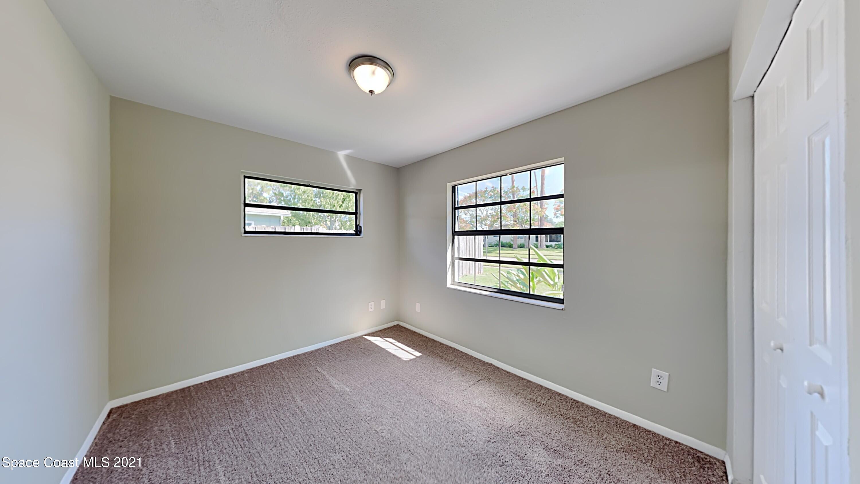 955 Lexington Road Rockledge, FL 32955 - Photo 12 of 18 an empty room with windows