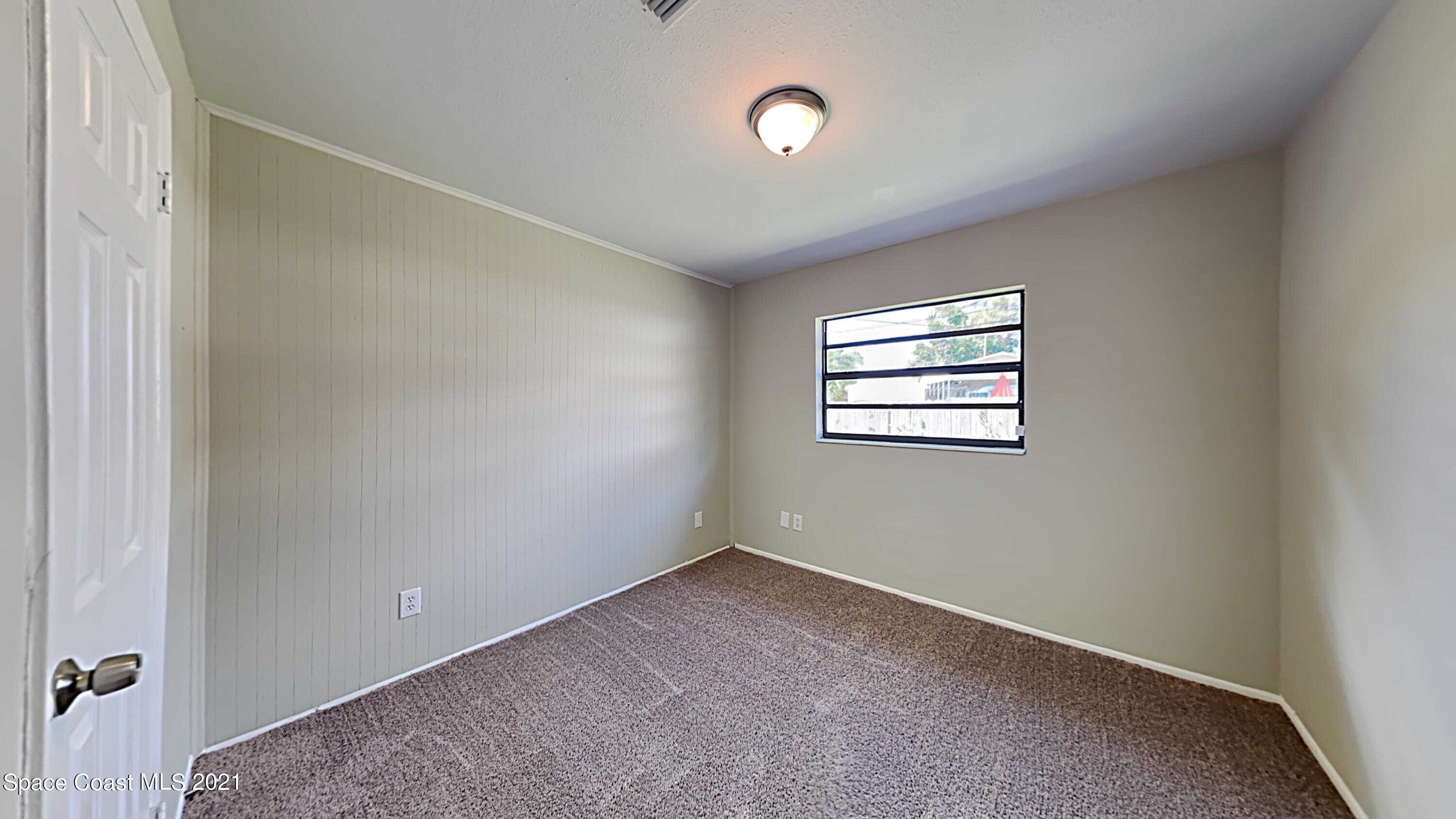 955 Lexington Road Rockledge, FL 32955 - Photo 13 of 18 an empty room with windows