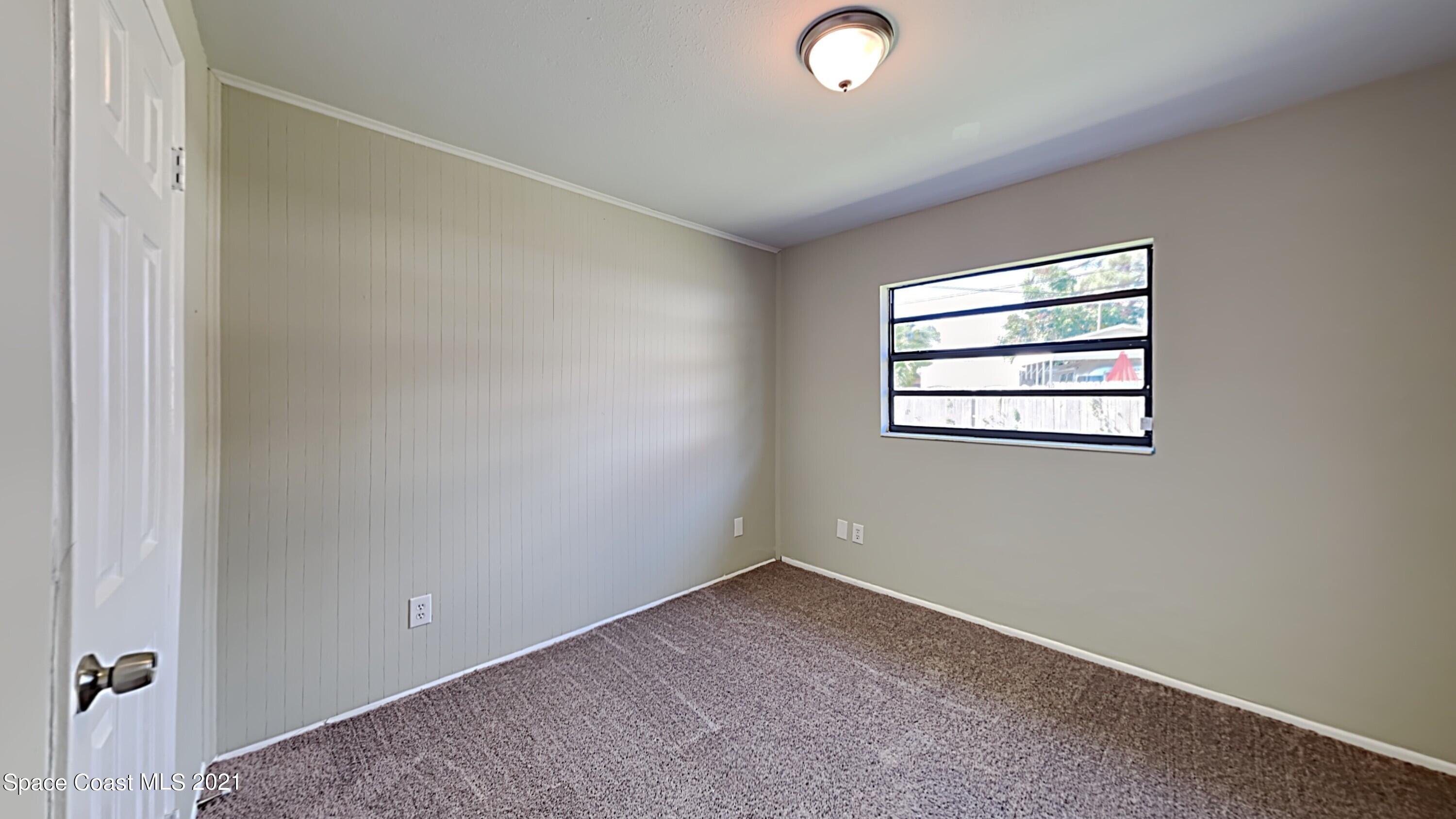 955 Lexington Road Rockledge, FL 32955 - Photo 14 of 18 an empty room with windows