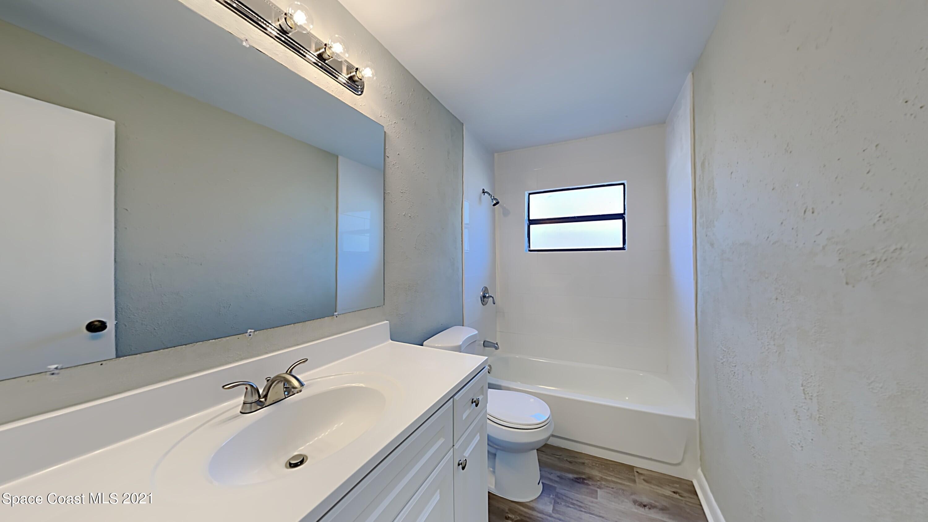 955 Lexington Road Rockledge, FL 32955 - Photo 15 of 18 a bathroom with a sink a toilet and shower