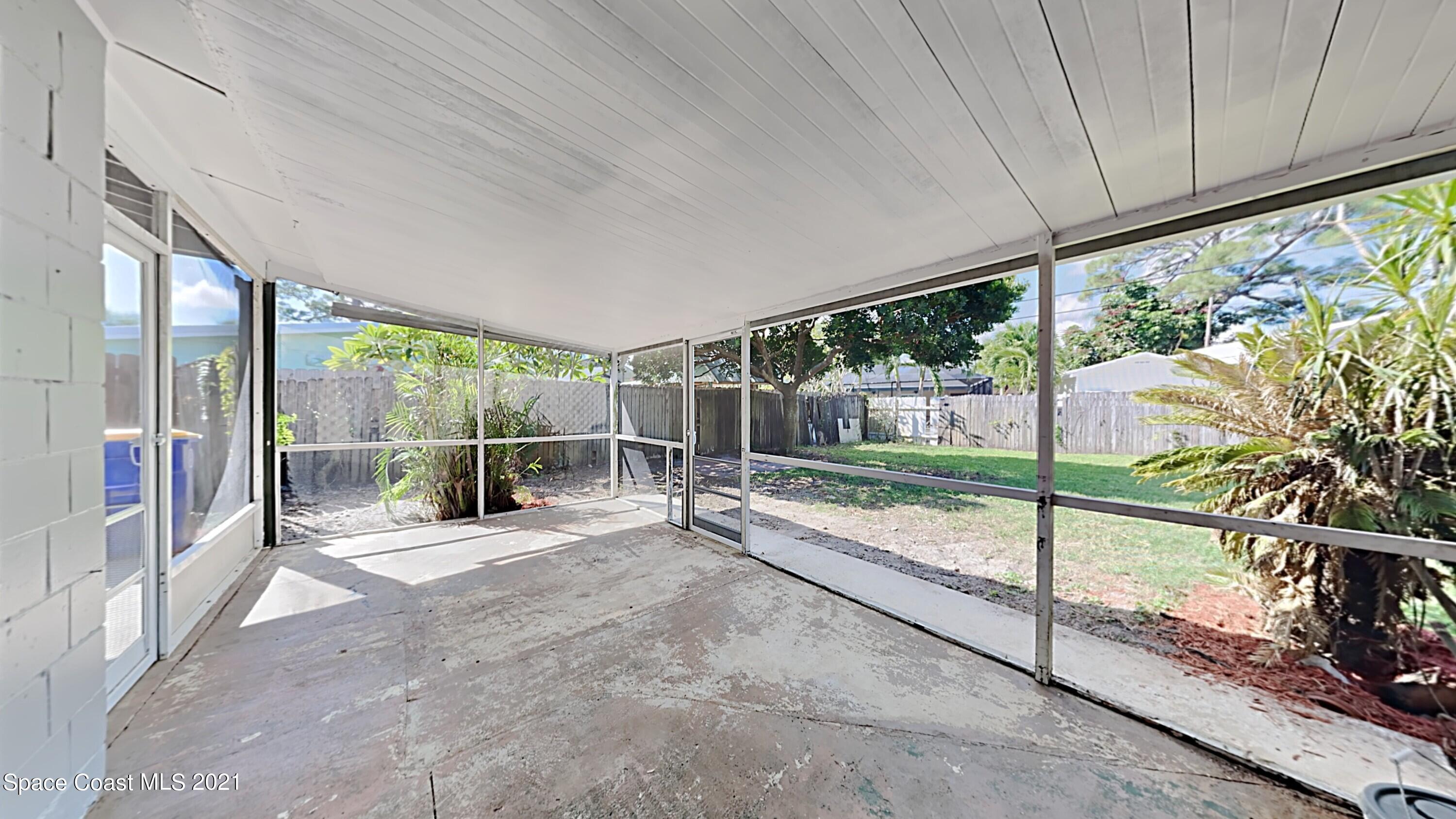 955 Lexington Road Rockledge, FL 32955 - Photo 16 of 18 a view of a porch with wooden floor and roof