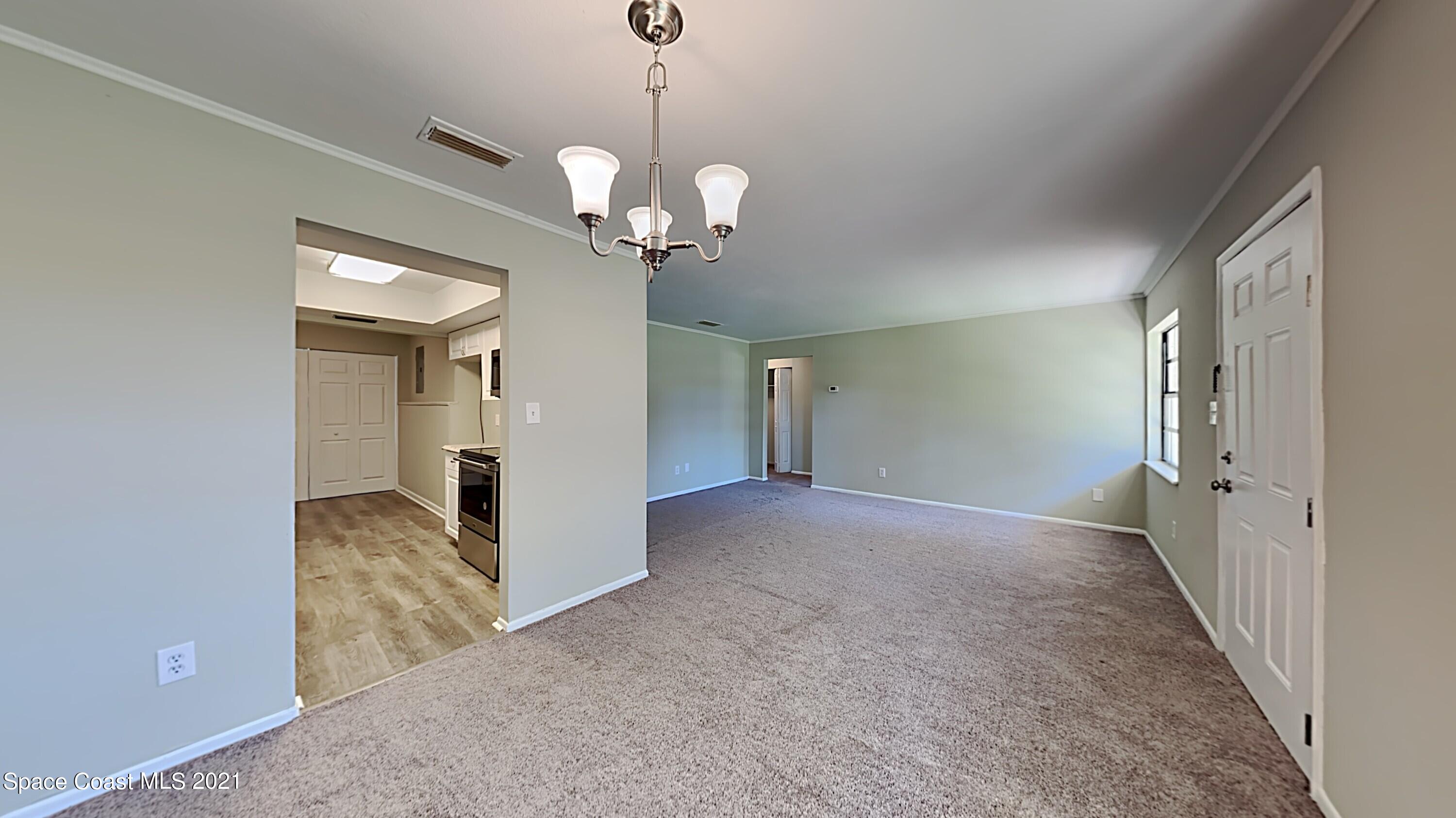955 Lexington Road Rockledge, FL 32955 - Photo 3 of 18 a view of a livingroom with a chandelier