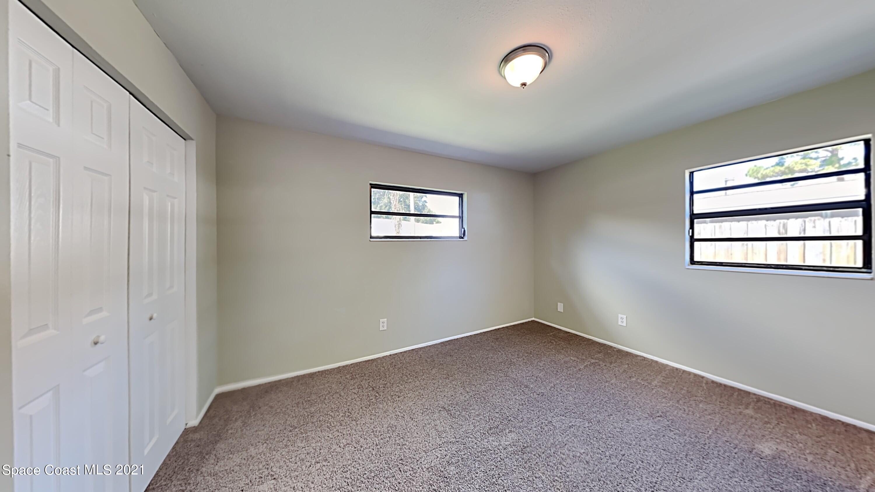 955 Lexington Road Rockledge, FL 32955 - Photo 9 of 18 an empty room with windows