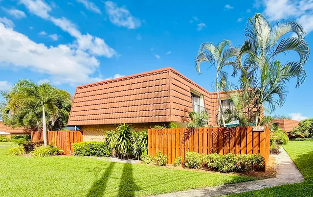 a view of a swimming pool with an outdoor seating and a garden