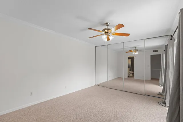 a view of a livingroom with a ceiling fan and window