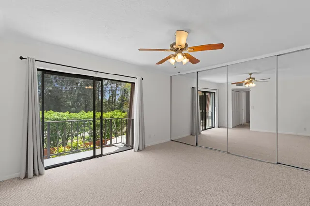 a bathroom with a granite countertop sink toilet a mirror and shower