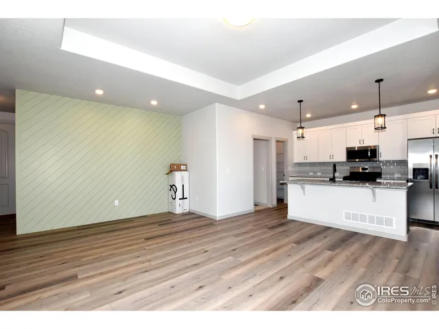 a view of kitchen with stainless steel appliances kitchen island a refrigerator sink and microwave