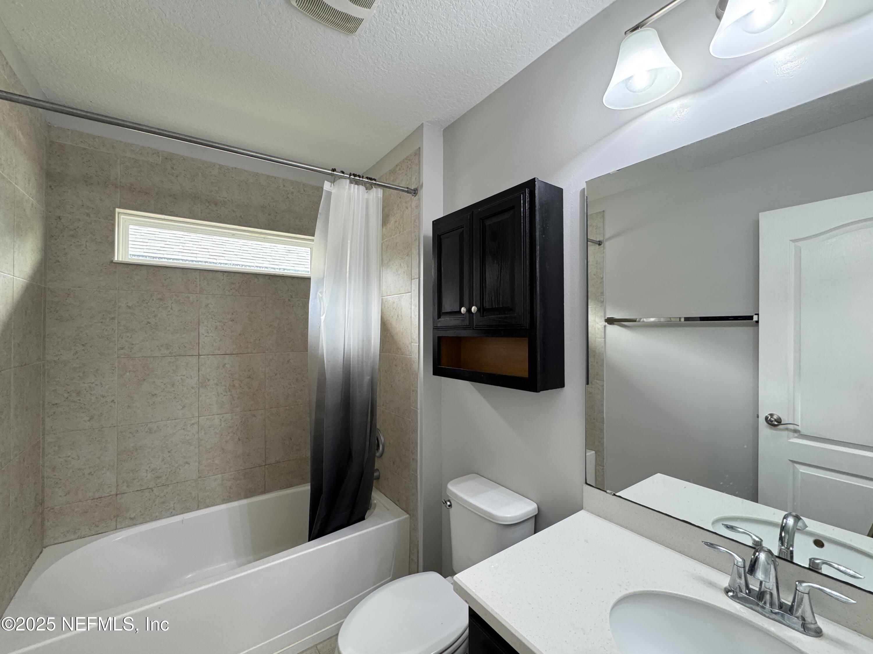 94267 Woodbrier Circle Fernandina Beach, FL 32034 - Photo 15 of 32 a bathroom with a sink toilet and shower