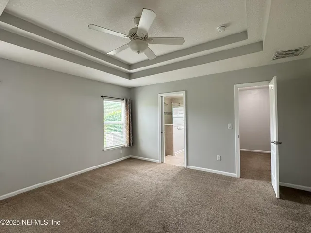 wooden floor in an empty room with a large window