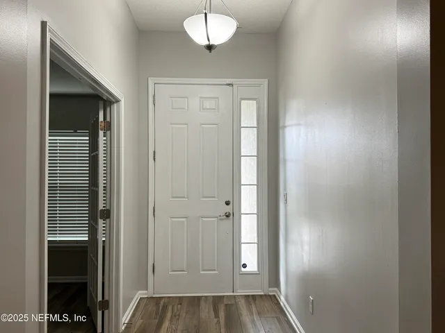 a kitchen with stainless steel appliances granite countertop a sink a stove and a wooden floors