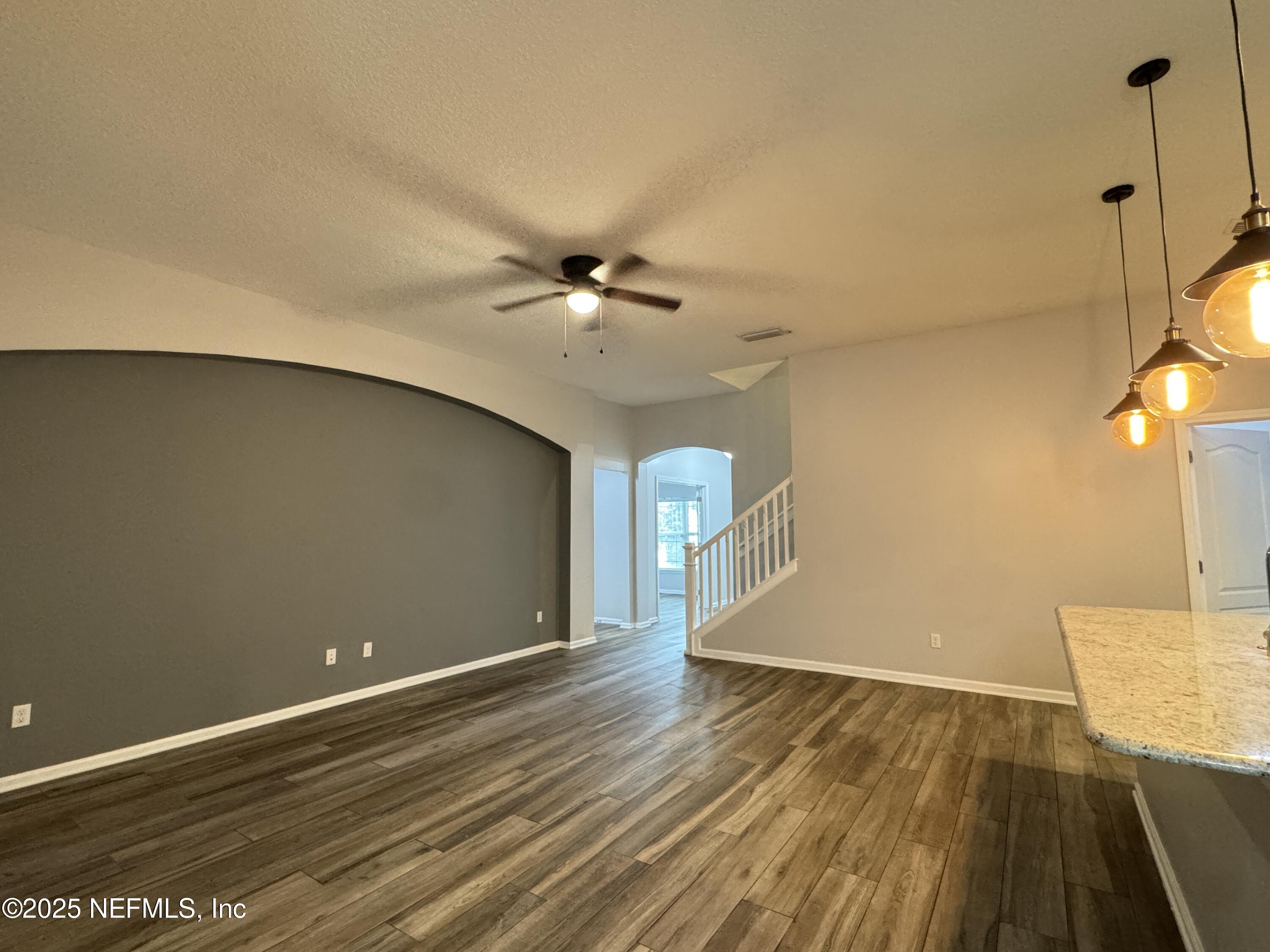 94267 Woodbrier Circle Fernandina Beach, FL 32034 - Photo 9 of 32 a view of an empty room with wooden floor