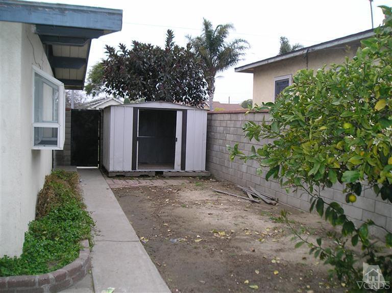 4900 Saviers Road Oxnard, CA 93033 - Photo 10 of 14 a view of a house with a yard and garage