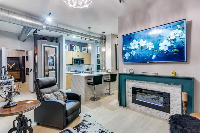 a living room with furniture a flat screen tv and a fireplace