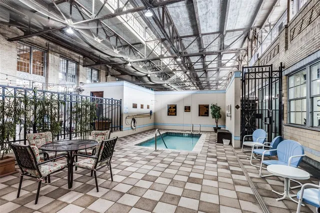a city street lined with parked cars front of buildings