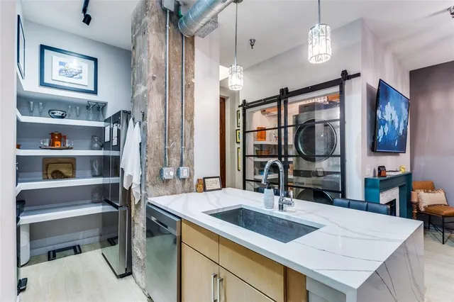 a kitchen with a stove a refrigerator and a dining table