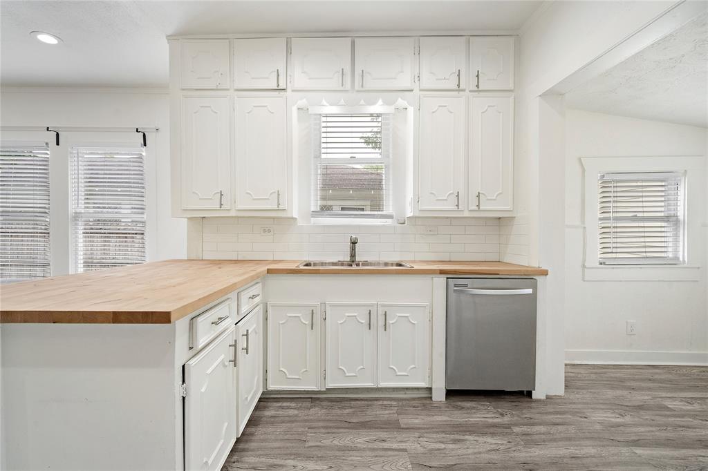 a kitchen with granite countertop cabinets stainless steel appliances a sink and a window