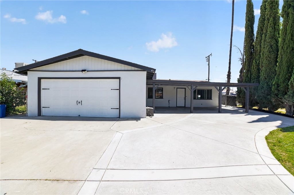 116 Doyle Avenue Redlands, CA 92374 - Photo 1 of 11 a front view of a house with a yard and garage