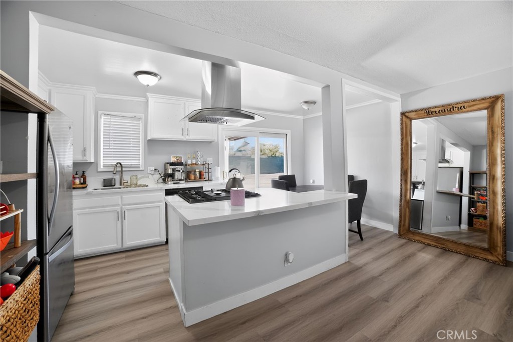 116 Doyle Avenue Redlands, CA 92374 - Photo 4 of 11 a kitchen view with stainless steel appliances a sink cabinets and wooden floor
