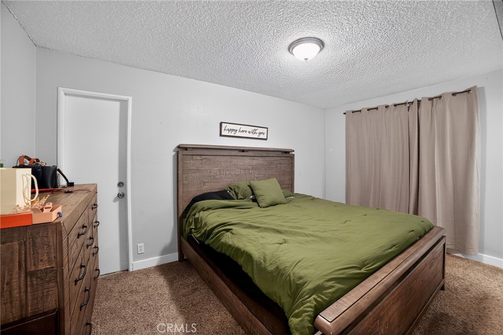 116 Doyle Avenue Redlands, CA 92374 - Photo 5 of 11 a bedroom with a bed and a dresser